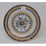 A set of three 19th century Dutch Delft polychrome plates, with floral decoration, 23 cm diameter