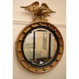 A Regency style wall mirror, in a ball stud frame, surmounted an eagle, 84 cm high