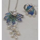 A silver plique-à-jour style enamel and pearl pendant, on a silver chain, and a matching ring,