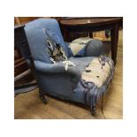 A Howard style upholstered armchair, on turned front legs (in need of re-upholstering)