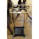 A brass and cast iron four division stick stand, 61 cm high