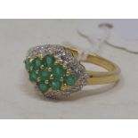 A 9ct gold, emerald and diamond cluster ring, approx. ring size N½ Modern