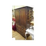 A mahogany linen press, with panel doors above two short and two long drawers, 130 cm wide Report by