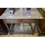 An 18th century oak table, with a frieze drawer, on bobbin turned legs, joined by similar