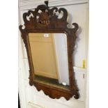 A George II style fret carved walnut mirror, 55 cm wide