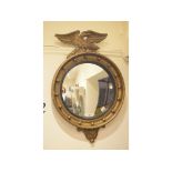 A Regency style convex wall mirror, with an eagle surmount, 47 cm wide