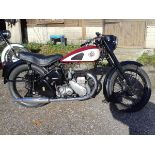 A 1954 BSA M21, registration number 897 UYX, red/black. The large sidevalve BSA was reintroduced