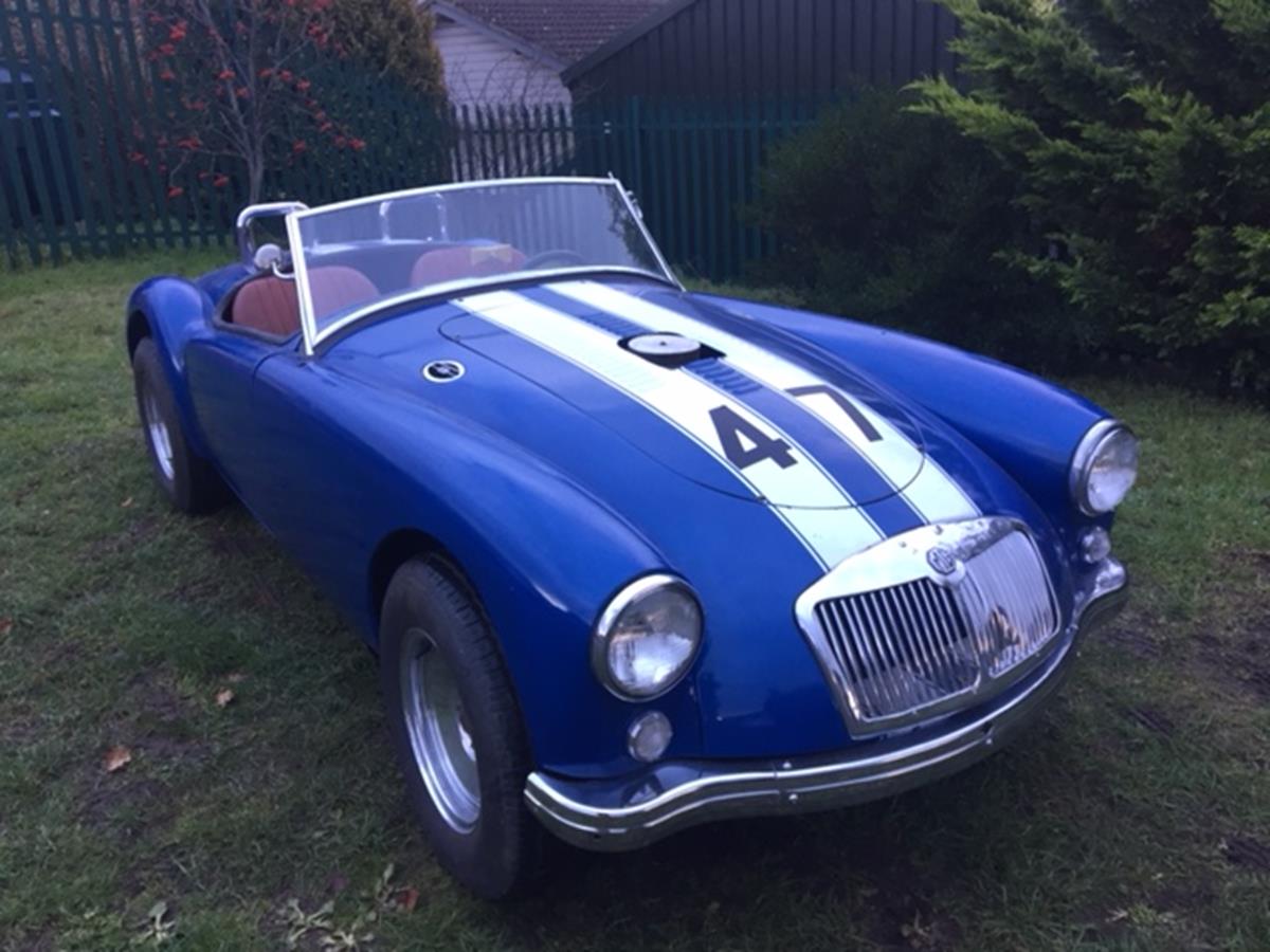 A 1959 LHD MG A roadster, US registered, blue with racing white stripes.