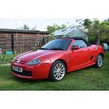 A 2002 MG TF 160, registration number BG02 MMG, red. The MG has a works hard top finished in black