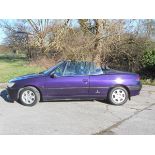 A 1999 Peugeot 306 cabriolet, registration number T862 TCF, purple. The Pininfarina designed 306