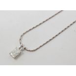 A diamond pendant, in a white coloured metal setting, on a chain Report by GH Approx. 6 x 5 x 3 mm