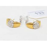 A pair of 18ct white and yellow gold earrings, set diamond flowerheads Report by NG They are approx.