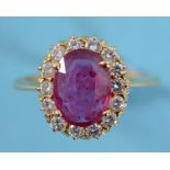 A ruby and diamond cluster ring, in a yellow coloured metal setting, approx. ring size M See