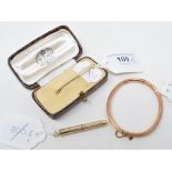 A 9ct gold cigar pricker, with engine turned decoration, a 9ct gold bangle and a 9ct gold tie pin,