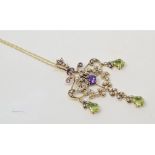 An Art Nouveau style 9ct gold, amethyst, peridot and seed type pearl pendant, on a 9ct gold chain