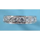 A white coloured metal and diamond half eternity ring, approx. ring size M½ See illustration