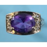 An oval amethyst and diamond ring, in a white coloured metal setting, with pierced and engraved