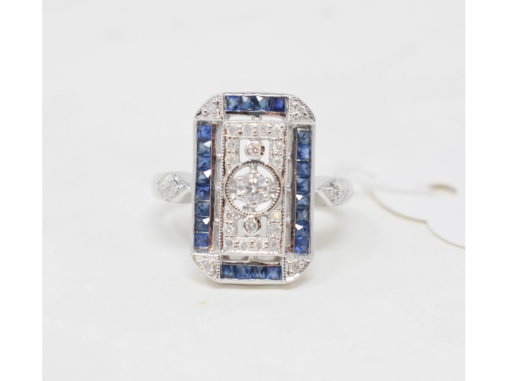 An Art Deco style 9ct white gold, diamond and sapphire panel ring, approx. ring size O Report by