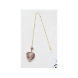 A 9ct gold, ruby and diamond heart shape locket, with a fleur-de-lys motif, on a 9ct gold chain