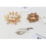 A 14ct gold and simulated pearl flowerhead brooch, a 19th century brooch, a silver brooch, and a 9ct