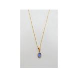 An oval sapphire pendant, in a yellow coloured metal mount, on an 18ct gold chain