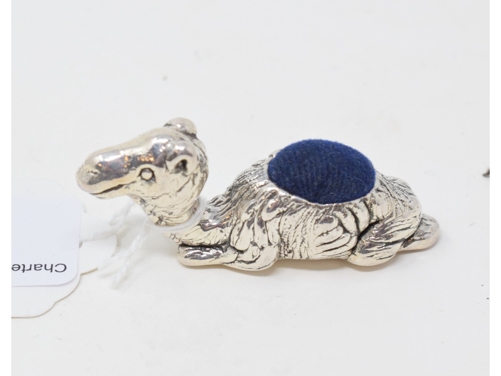 A novelty silver pincushion, in the form of a camel, 2.5 cm high Report by NG Modern