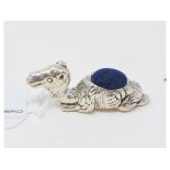 A novelty silver pincushion, in the form of a camel, 2.5 cm high Report by NG Modern