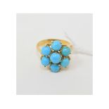 A yellow coloured metal and turquoise flowerhead brooch, approx. ring size O