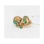 An Eastern gold coloured metal ten stone emerald crossover ring, approx. 3.8 g, approx. ring size M