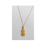 A yellow coloured metal filigree pendant, on an 18ct gold rope twist chain, approx. 7.3 g (all in)