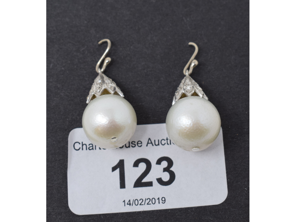 A pair of large cultured pearl and diamond drop earrings Believed 18ct gold