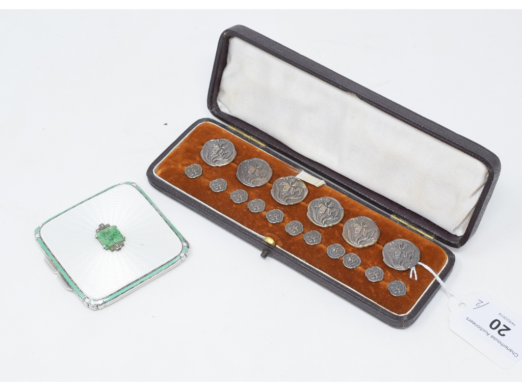 A silver and enamel compact, with cover set a pierced jade plaque, flanked by marcasites, Asprey