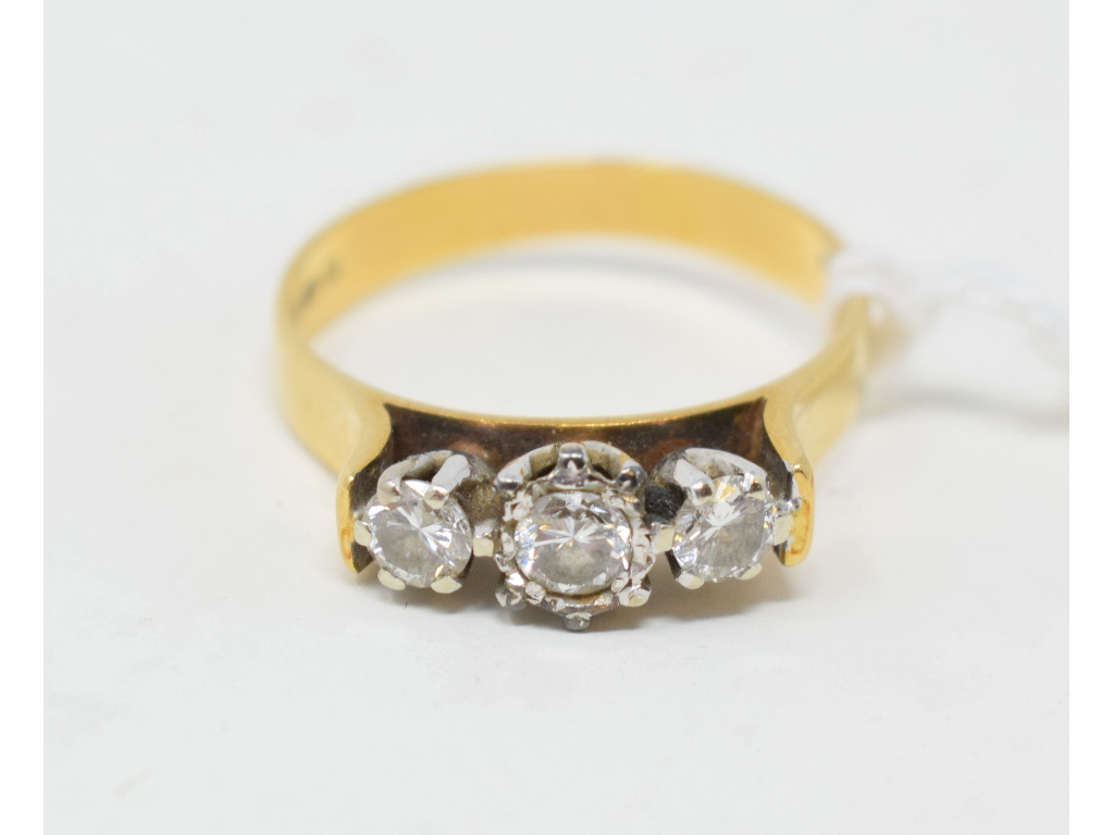 An 18ct gold and three stone diamond ring, approx. ring size Q½ Approx. 4.1 g (all in) Report by