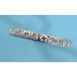 A white coloured metal and diamond eternity ring, approx. ring size U See illustration