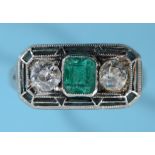 An Art Deco three stone emerald and diamond ring, in a white coloured metal mount with pierced and