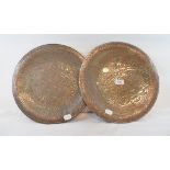 A pair of Islamic copper chargers, with silver coloured metal calligraphy and animal inlay, 35 cm