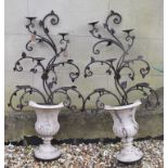 A pair of six light candle holders, in the form of urns with foliage, 115 cm high