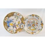 A Dutch polychrome Delft plate, decorated a vase of flowers and a bird, 33.5 cm diameter, and