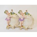Two German porcelain menu holders, applied putto, 14 cm high, Continental, nodding and other figures
