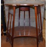 An Art Nouveau style mahogany two tier table, of shaped oval form, 63 cm wide