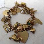 A 9ct gold bracelet, with assorted 9ct and other charms, including an opening dog kennel with dog,