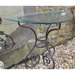 A wrought iron console table, with a glass top, 89 cm wide