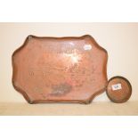 A Cornish copper tray, decorated a tin mine, 39 cm wide and a similar coaster (2)