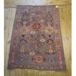 An Eastern rug, decorated stylised flowers and motifs on a grey ground, within a multi border, 165 x