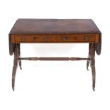 An early 19th century mahogany sofa table, crossbanded, having two real and two false drawers, on