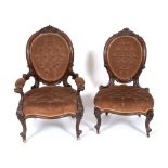 A Victorian walnut armchair, carved flowers and foliage, on cabriole front legs with knurl feet, and