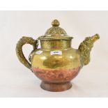 A Tibetan copper and brass teapot with embossed decoration, 26 cm high