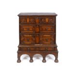 A 17th century oak chest on stand, having three long drawers with geometric moulded fronts, the