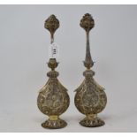 An Indian pair of silver coloured metal filigree work rosewater sprinklers, 34 cm high, another