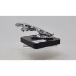 A leaping Jaguar car mascot, on a perspex base, 6 cm high